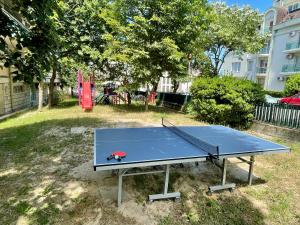 a ping pong table in a yard with a playground at AMADINA GARDEN - Bed & Breakfast or Half Board in Lozenets