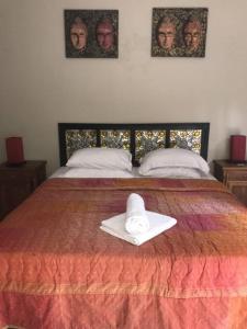 a white hat sitting on top of a bed at Spacious Private Pool Apartment-Beachside Resort in Candidasa