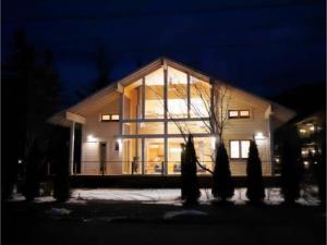 a large house with lights on in the night at Polar House Karuisawa - Vacation STAY 30319v in Kutsukake