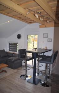 a living room with a table and some chairs at Apartmani Katruža in Sveti Martin na Muri