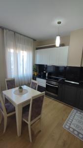 a kitchen with a table and chairs in a room at Tirana New Bazaar-Apartment 1 in Tirana