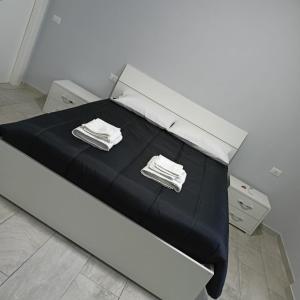 a white bed with two towels on top of it at Affittacamere Sole e Luna in Castel San Giorgio