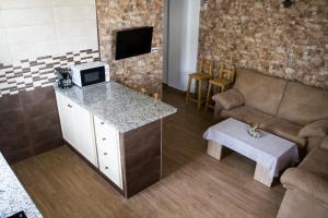 a kitchen with a couch and a counter with a microwave at La Vega in Tarifa