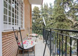 a balcony with two chairs and a window at Sofia’s home in Rome