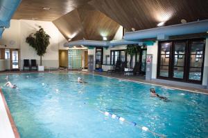 a group of people swimming in a swimming pool at Lancaster House Hotel in Lancaster