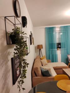 a living room with a couch and a table at Krstić_lux apartman in Subotica