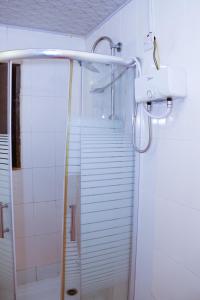 a shower in a bathroom with a sink and a shower at Dolly Apartments in Nairobi