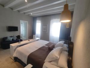 a bedroom with a large bed and a couch at XII Century Heritage Hotel in Trogir