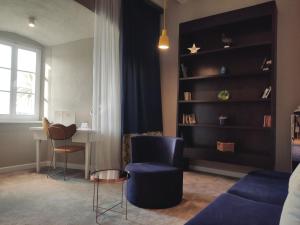 a living room with a blue couch and a table at XII Century Heritage Hotel in Trogir