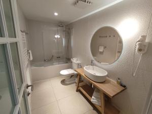 a bathroom with a sink and a toilet and a mirror at XII Century Heritage Hotel in Trogir