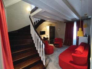 a living room with a staircase and a red couch at XII Century Heritage Hotel in Trogir