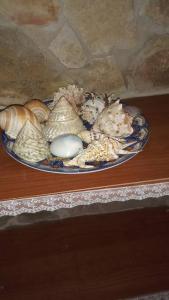 a plate of shells and eggs on a table at CASA FIORITA in Rodi Garganico