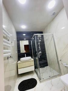 a bathroom with a shower and a toilet and a sink at Narimanova Residence in Baku