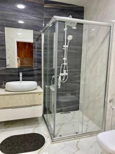 a bathroom with a shower and a sink at Narimanova Residence in Baku