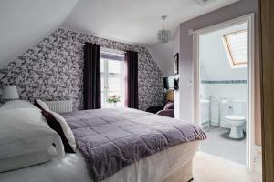 a bedroom with a large bed and a bathroom at Lee House in Lynton