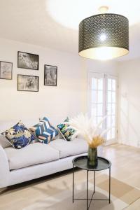 a living room with a white couch and a table at Bee Stays - Maliston House in Great Sankey