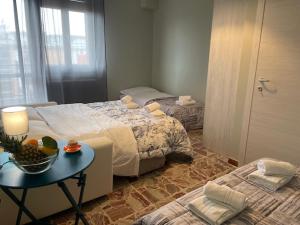 Un dormitorio con 2 camas y una mesa con un bol de fruta en Dal Ciandri, en Pisa