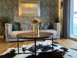 a living room with a couch and a coffee table at Luxury Riverfront Apartment in Newport