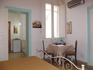 a dining room with a table and a window at La Dimora Siciliana in Trapani