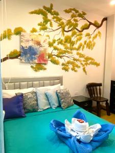 a bedroom with a bed with two dishes on it at Hotel boutique stay la 10 in Medellín
