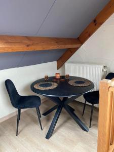 a table with two chairs and two cups on it at Au Refuge du Bois in Walhain-Saint-Paul