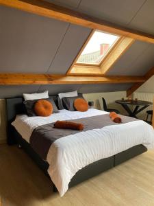 ein Schlafzimmer mit einem großen Bett im Dachgeschoss in der Unterkunft Au Refuge du Bois in Walhain-Saint-Paul