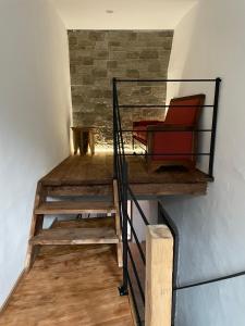 a room with a staircase with red chairs on it at casa FABBRO in Avegno