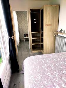 a bedroom with a bed and an open door at 36 Dajot Boutique Apartment - 70 in Melun