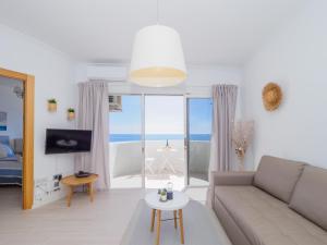 a living room with a couch and a view of the ocean at Apartment on Beach Mijas 2 in Sitio de Calahonda