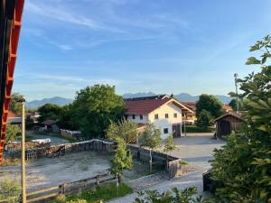 Blick auf ein Dorf mit Häusern und einer Straße in der Unterkunft Ferienwohnungen Reschenhof in Rosenheim