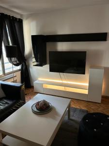 uma sala de estar com uma grande televisão na parede em Chez mimi em Toulouse