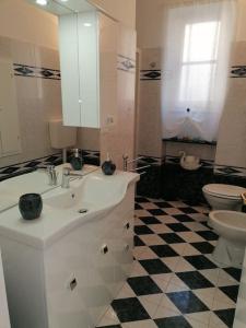 a bathroom with a white sink and a toilet at Casa Andreina in Salto +13 photos