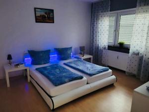 a bedroom with a bed with blue lights on it at Appartment in Walldorf mit Schlafzimmer, Küche und Bad in Walldorf