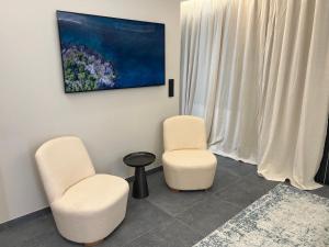 two chairs and a table in a room at Palm croisette front de mer1 in Cannes