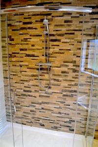 a shower in a room with a wooden wall at Holiday home in Falcarragh, Gortahork, Donegal in Falcarragh