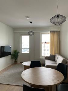 a living room with a table and a couch at Viola apartments in Rovaniemi