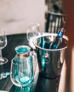 a bottle of wine in a bucket on a table with glasses at Dolphin Village - Sea Resort By Ran Hotels in Shave Ẕiyyon