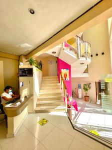 a staircase in a building with a pink wall at Hotel Barranquilla in Campeche