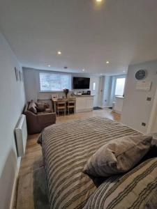 a bedroom with a large bed and a living room at The Patch in Brighton & Hove