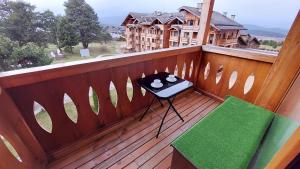 a balcony with a table on a wooden deck at Сладко студио в Пирин с голф и СПА комплекс in Razlog