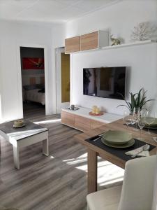 a living room with a table and a dining room at Casa junto al mar in Blanes