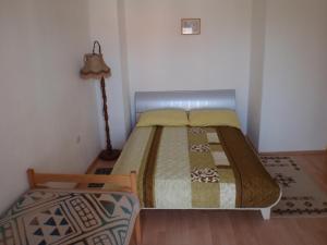 a small bedroom with a bed and a rug at Apartments Silo in Šilo