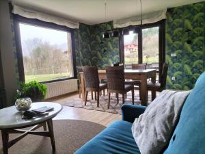 a living room with a blue couch and a table at Leku eder in Areatza