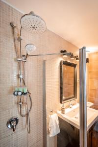 a bathroom with a shower and a sink at Dolphin Village - Sea Resort By Ran Hotels in Shave Ẕiyyon