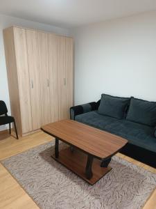 a living room with a couch and a coffee table at 2BDR Apt with Balcony with view- Free Parking in Sarajevo