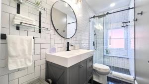 a white bathroom with a sink and a mirror at Modern/Luxury 2 bdrm- KING Bed- University City in Philadelphia