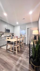 a kitchen and dining room with a table and chairs at Modern/Luxury 2 bdrm- KING Bed- University City in Philadelphia