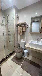 a bathroom with a shower and a toilet and a sink at APPARTEMENT de LUXE au COEUR de Oujda - City Budget Coralia in Oujda +22 photos