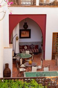 a patio with a table and chairs and a couch at Riad Tafilag in Taroudant