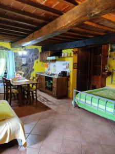 a kitchen and dining room with a bed and a table at Castello di Casallia in Vetulonia